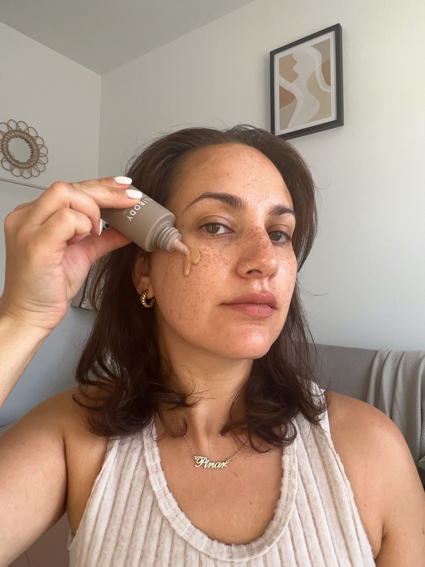 Applying Bali Body Tinted serum to face